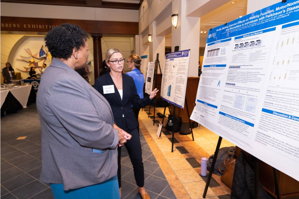 Shannon (right) presenting to a guest at the 2023 Graduate Showcase.
